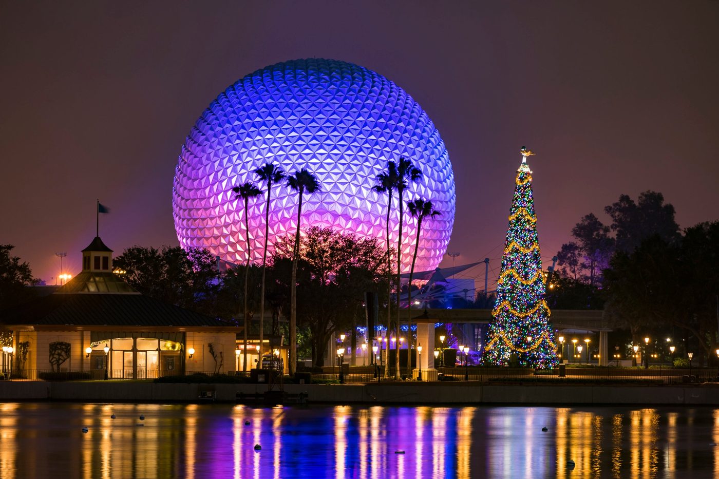 Spaceship Earth at EPCOT reflected in the lagoon at night