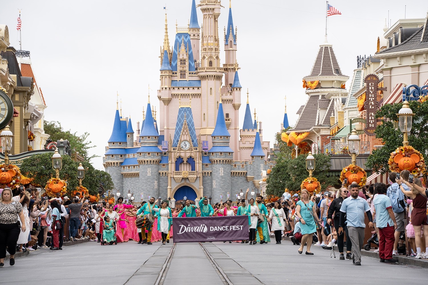 Studios parading down Main Street USA toward Cinderella Castle