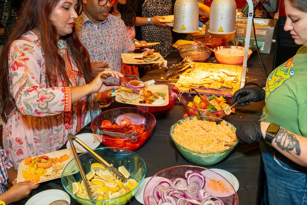 Guests enjoying the Diwali party buffet
